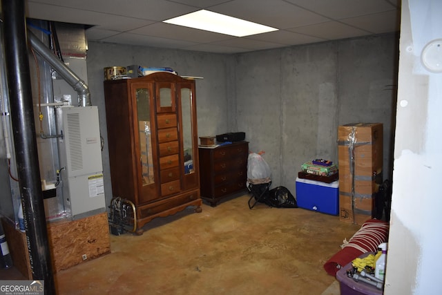 interior space with concrete floors and a paneled ceiling