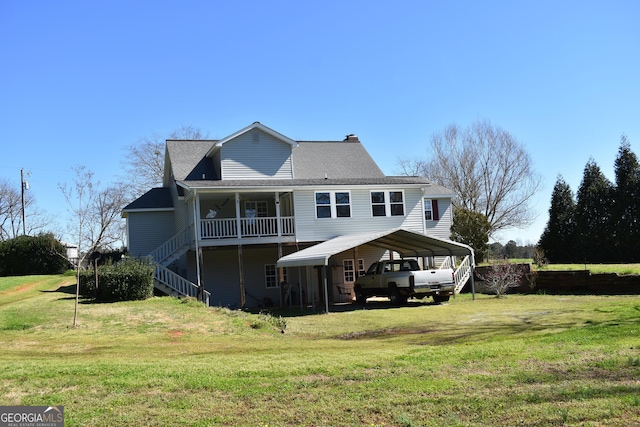 back of house featuring a lawn and a carport