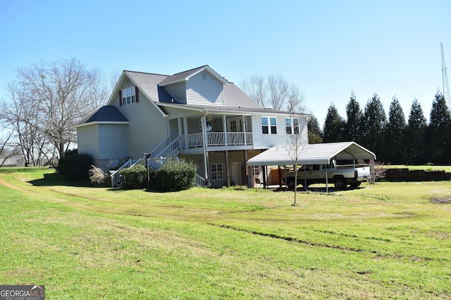 back of property with a porch, a lawn, and a carport