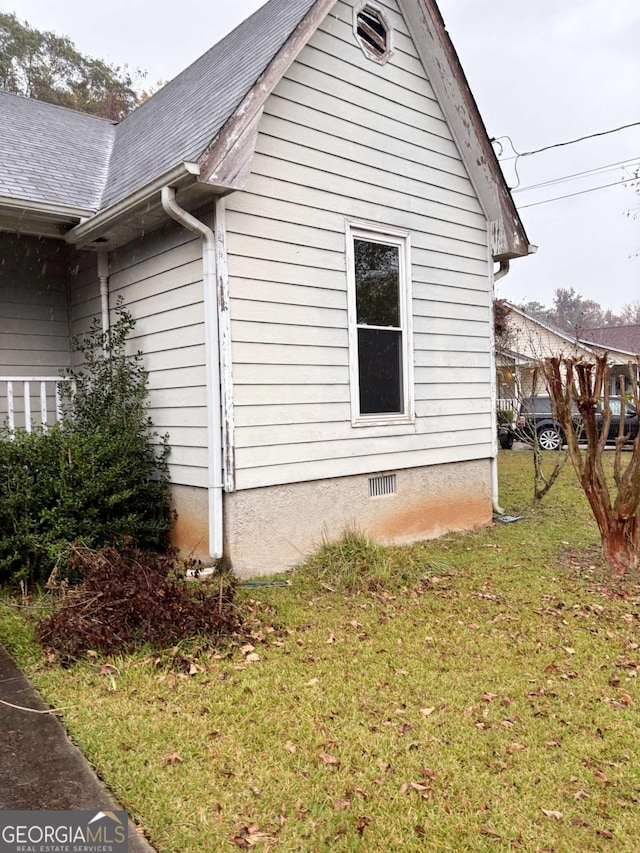 view of property exterior with a lawn