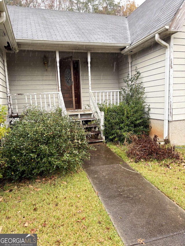 view of exterior entry with covered porch