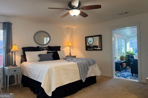 bedroom featuring multiple windows, access to exterior, and ceiling fan