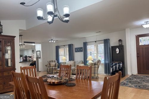 dining space with a chandelier and light hardwood / wood-style floors