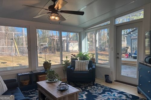 sunroom / solarium featuring lofted ceiling