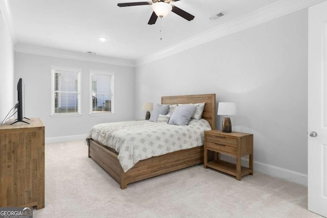 carpeted bedroom featuring crown molding and ceiling fan