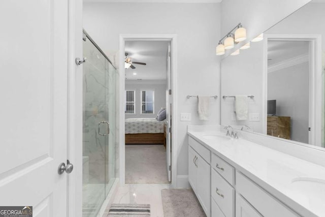 bathroom with vanity, a shower with shower door, and ornamental molding