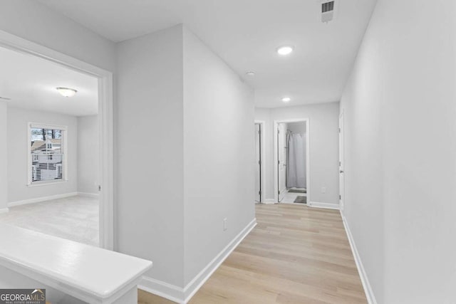 hallway with light wood-type flooring