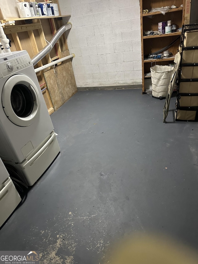 interior space featuring washer / dryer and concrete block wall