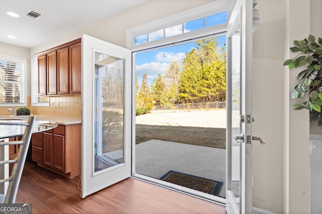 doorway with dark hardwood / wood-style floors