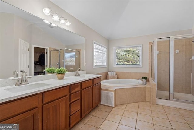 bathroom featuring vanity, lofted ceiling, shower with separate bathtub, and tile patterned floors