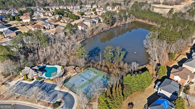 birds eye view of property with a water view