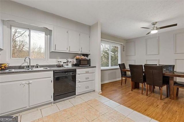 kitchen with white cabinets, dishwasher, sink, ceiling fan, and light tile patterned floors