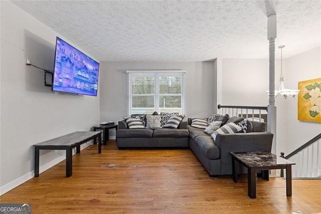 living room with hardwood / wood-style flooring and a textured ceiling