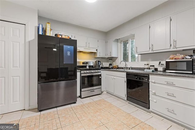 kitchen with white cabinets, stainless steel appliances, light tile patterned flooring, and sink