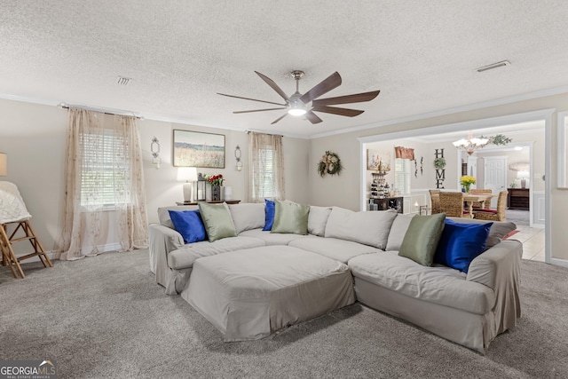 carpeted living room featuring ceiling fan with notable chandelier, a textured ceiling, and ornamental molding