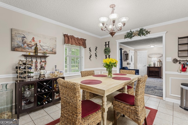 dining space featuring a textured ceiling, crown molding, and light tile patterned flooring