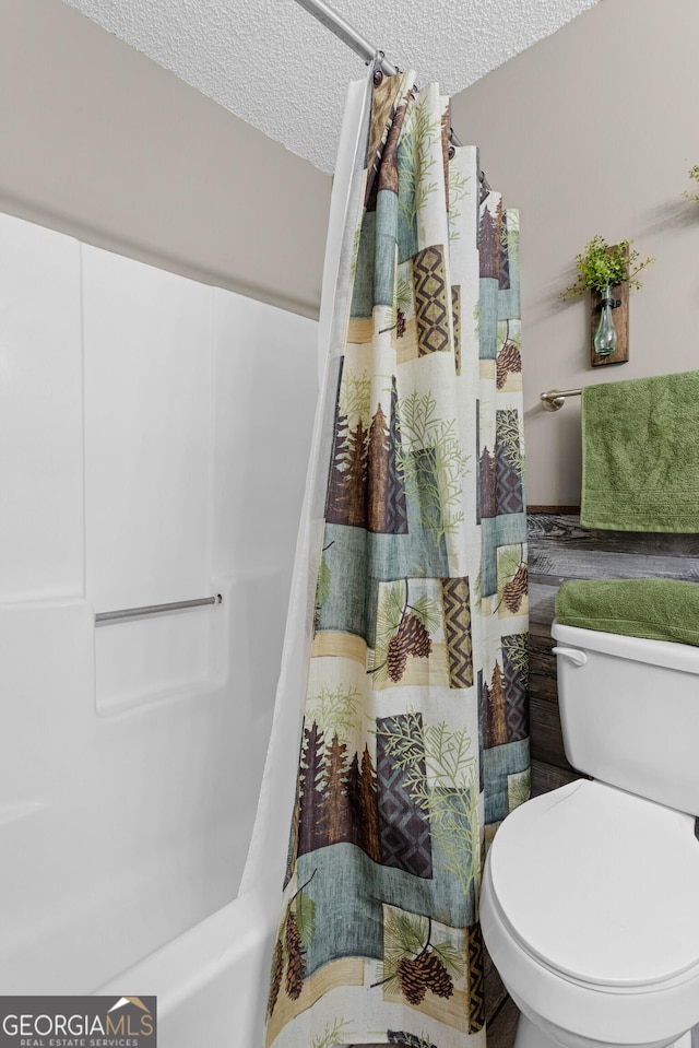 bathroom featuring toilet and a textured ceiling