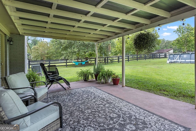 view of patio / terrace with a fenced in pool