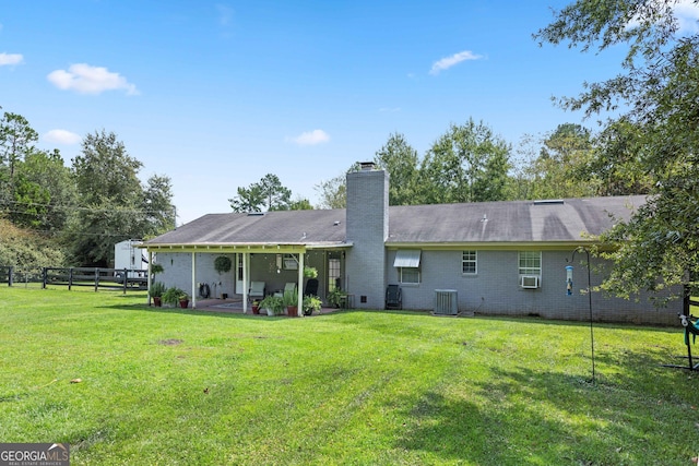 back of house with a patio area, a yard, and cooling unit