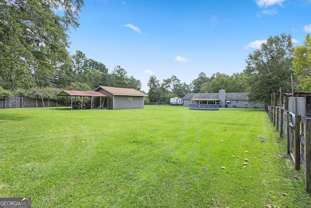 view of yard with a pool and a carport