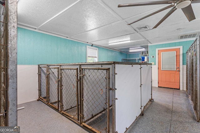 basement featuring wooden walls