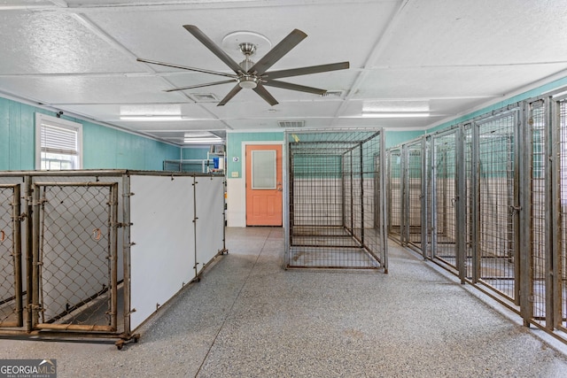 interior space with ceiling fan