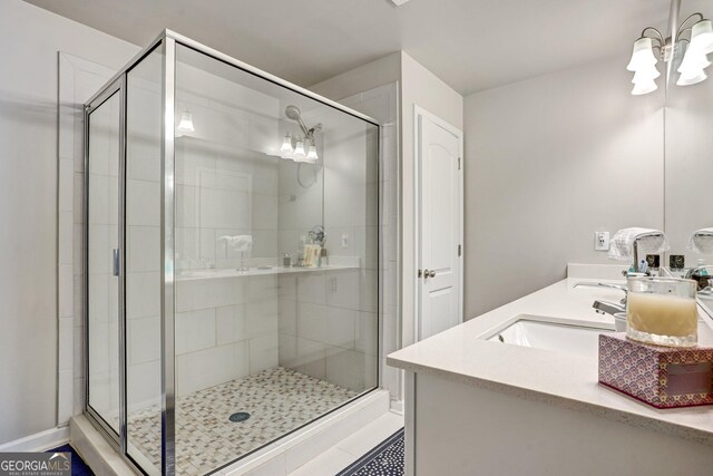 bathroom with a shower with shower door, tile patterned floors, and vanity