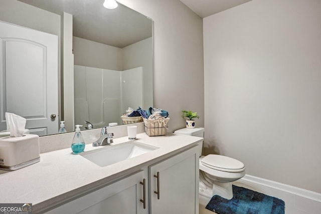 bathroom featuring tile patterned floors, toilet, walk in shower, and vanity