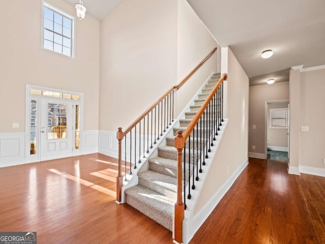 stairway with hardwood / wood-style flooring and a wealth of natural light