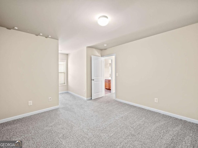 spare room featuring light colored carpet