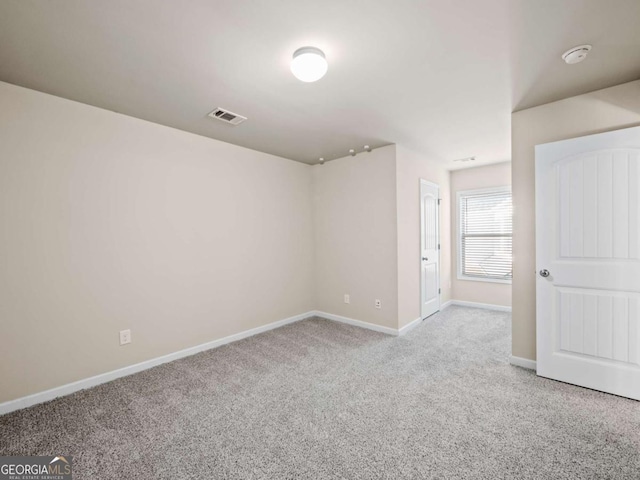 unfurnished room with light colored carpet