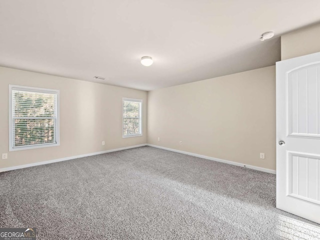 carpeted empty room with a wealth of natural light