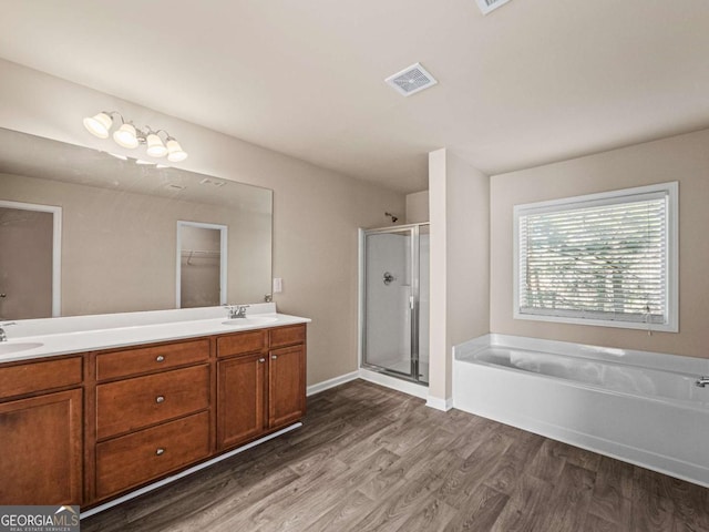 bathroom with vanity, separate shower and tub, and wood-type flooring