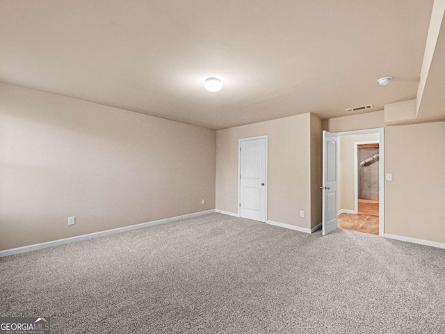 unfurnished bedroom featuring light carpet and a closet