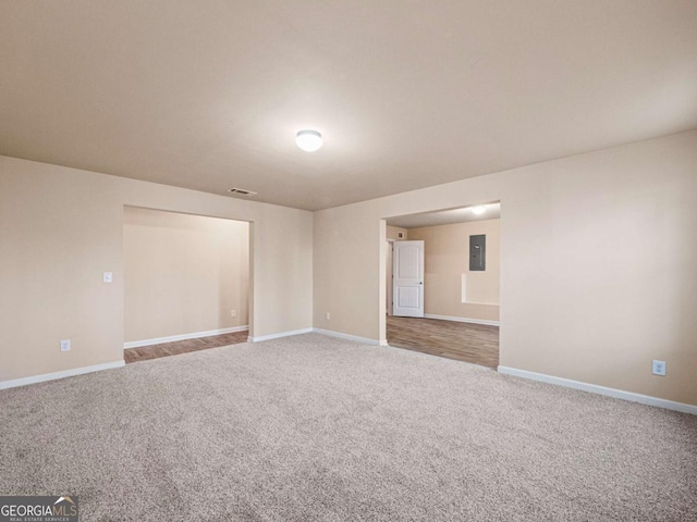 carpeted spare room featuring electric panel