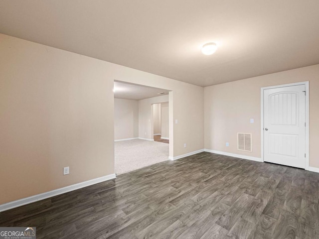 unfurnished room featuring dark hardwood / wood-style floors