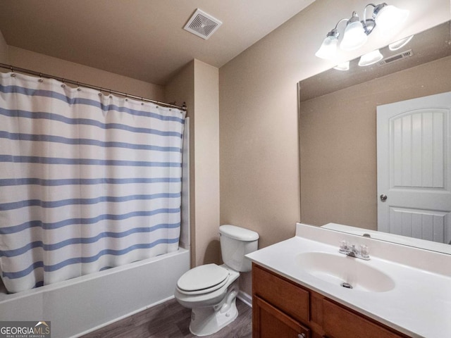 full bathroom with wood-type flooring, shower / bath combo, toilet, and vanity