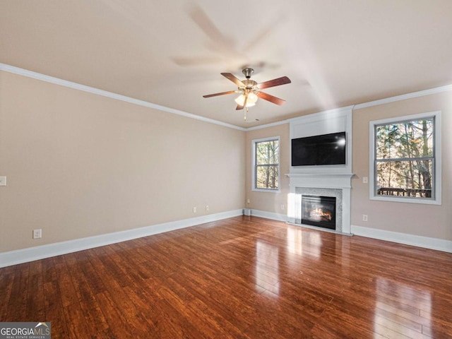 unfurnished living room with ceiling fan, wood-type flooring, and ornamental molding