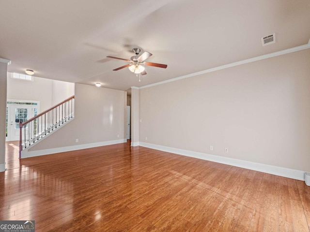 empty room with ceiling fan, crown molding, and hardwood / wood-style flooring