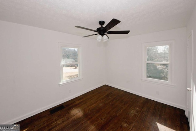 unfurnished room featuring ceiling fan, wood-type flooring, and a textured ceiling