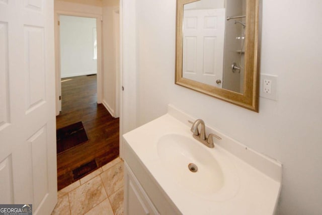 bathroom with walk in shower and vanity