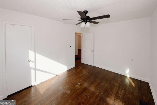 unfurnished room with ceiling fan and dark hardwood / wood-style floors