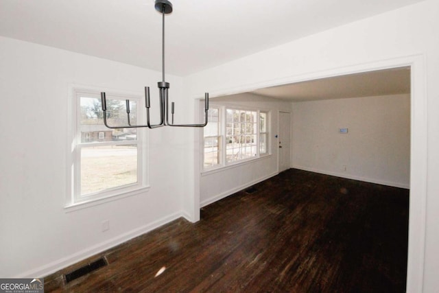 unfurnished dining area featuring dark hardwood / wood-style flooring