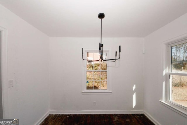 unfurnished dining area featuring dark wood-type flooring