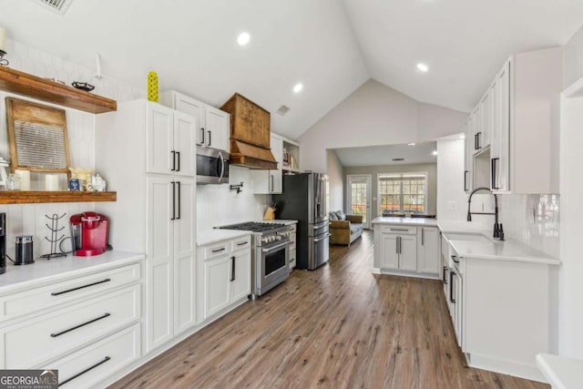 kitchen featuring sink, backsplash, white cabinets, and stainless steel appliances