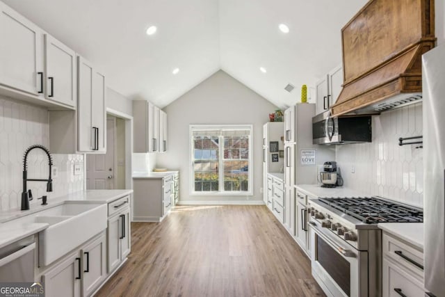 kitchen featuring sink, white cabinets, stainless steel appliances, and tasteful backsplash