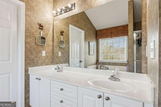 bathroom featuring vanity and lofted ceiling