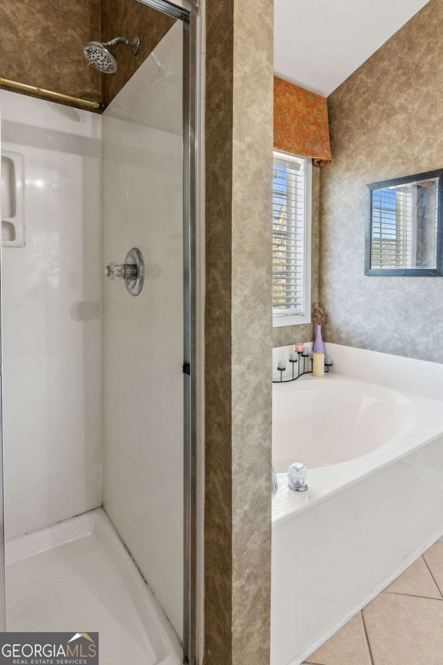 bathroom featuring plus walk in shower and tile patterned floors