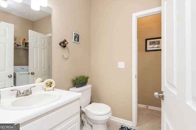 bathroom with toilet, tile patterned floors, and vanity