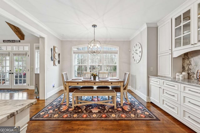 dining room with crown molding, a notable chandelier, a wealth of natural light, and dark hardwood / wood-style flooring